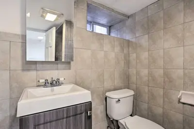 a bathroom with a sink and a toilet and a mirror at Charming Mamaroneck with 3BR and 3BA 22 Mi to Manhattan in Mamaroneck