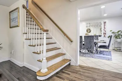 a staircase in a home with a living room and a dining room at Charming Mamaroneck with 3BR and 3BA 22 Mi to Manhattan in Mamaroneck