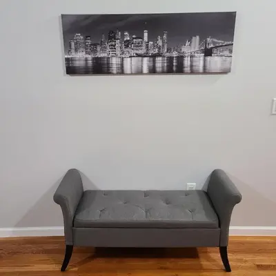 a couch in a room with a painting on the wall at Spacious Apt in Fairview NJ Easy Commute to NYC with parking in Fairview