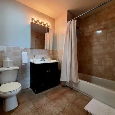 a bathroom with a toilet and a sink and a tub at Spacious Apt in Fairview NJ Easy Commute to NYC with parking in Fairview