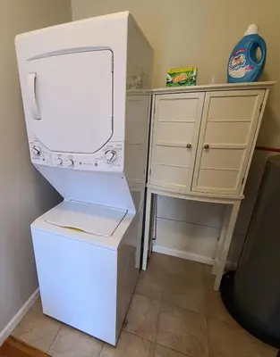 a white refrigerator in a kitchen with a desk at Spacious Apt in Fairview NJ Easy Commute to NYC with parking in Fairview
