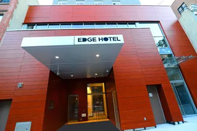 an office building with a sign that reads edge hotel at Edge Hotel Washington Heights in New York