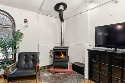 a living room with a fireplace and a tv at The Mahogany Villa Indoor pool Spa Sauna Gameroom in Dover