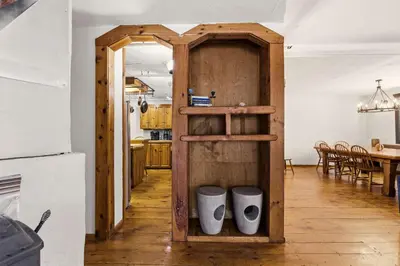 a kitchen with a wooden cabinet with two white pots at The Mahogany Villa Indoor pool Spa Sauna Gameroom in Dover