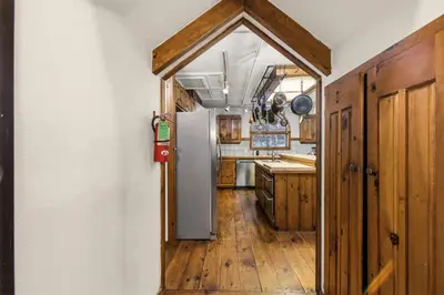 an open doorway to a kitchen with a refrigerator at The Mahogany Villa Indoor pool Spa Sauna Gameroom in Dover