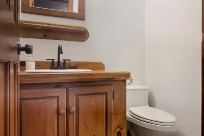 a bathroom with a toilet and a sink at The Mahogany Villa Indoor pool Spa Sauna Gameroom in Dover
