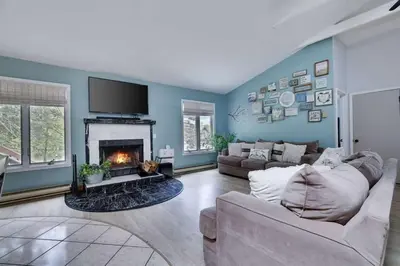 a living room with a couch and a fireplace at The Playhouse Retreat Large Game Room Fire Pit in Tobyhanna