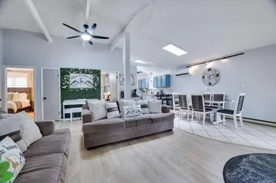 a living room with a couch and a dining room at The Playhouse Retreat Large Game Room Fire Pit in Tobyhanna