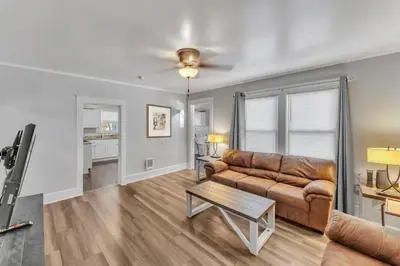 a living room with a couch and a table at The Main Lineup 2 - All Star Baseball Rentals in Oneonta