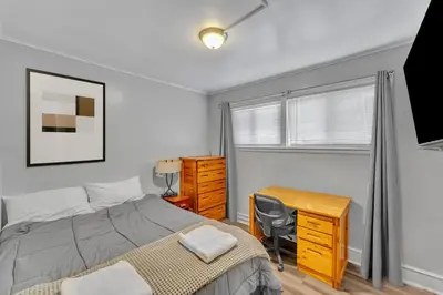 a bedroom with a bed and a desk and a desk at The Main Lineup 2 - All Star Baseball Rentals in Oneonta