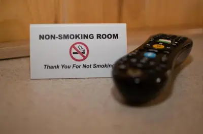 a remote control sitting on a counter next to a sign at Smith's Colonial Motel in Hancock