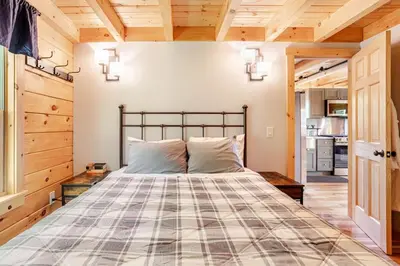 a bedroom with a large bed in a room at The Greylock Cabin in Florida