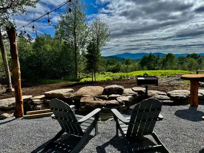 two chairs sitting next to a grill and a table at The Greylock Cabin in Florida
