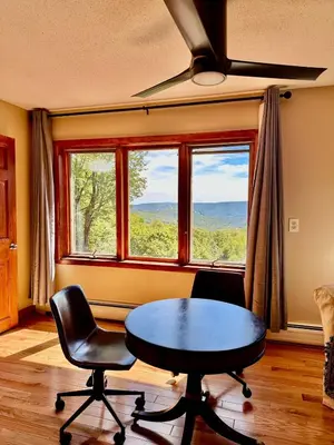 a room with a table and two chairs and a window at Charlemont Chalet - A 15 Acre Private Retreat in Charlemont