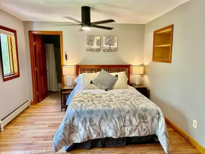 a bedroom with a bed and a ceiling fan at Charlemont Chalet - A 15 Acre Private Retreat in Charlemont