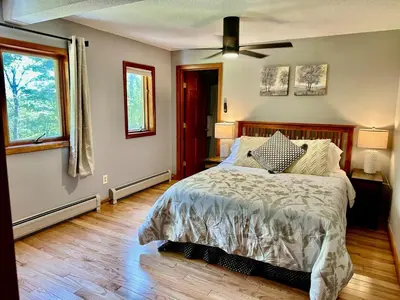 a bedroom with a bed and a ceiling fan at Charlemont Chalet - A 15 Acre Private Retreat in Charlemont