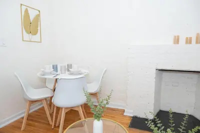 a dining room with a table and chairs and a fireplace at Stylish East Village Apartment12 close to Union Square Steps from NYC Best Restaurants & Shops in New York