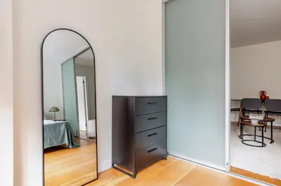 a large mirror in a room with a dresser at Blueground Midtown East view nr UN Plaza NYC-2114 in New York