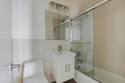 a bathroom with a toilet and a sink and a shower at Blueground Midtown East view nr UN Plaza NYC-2114 in New York