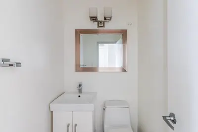 a bathroom with a sink and a mirror at Blueground Midtown East view nr UN Plaza NYC-2114 in New York