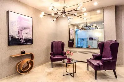 a waiting room with two purple chairs and a table at Blueground Lincoln Square fitness nr Central Park NYC-2102 in New York