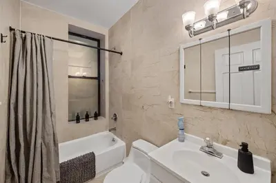 a bathroom with a sink and a toilet and a tub at The Global Nook - Private Room with Shared Bathroom near Times Square in New York