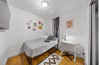 a bedroom with a bed and a desk and a window at The Global Nook - Private Room with Shared Bathroom near Times Square in New York
