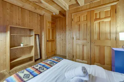 a bedroom with a bed in a wooden room at Year-Round Outdoor Adventures Poconos Hideaway in East Stroudsburg