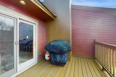 a suitcase sitting on a porch next to a house at Timber Creek #100 in Dover