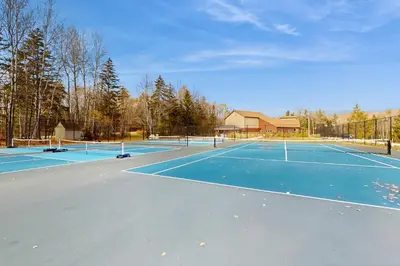 a tennis court with two tennis courts at Timber Creek #100 in Dover