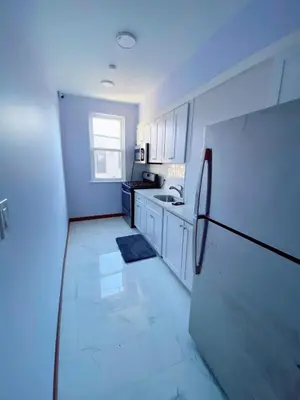 a kitchen with white cabinets and a black refrigerator at Amazing private Room in Glendale
