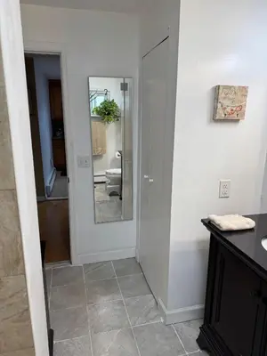 a bathroom with a mirror and a toilet in a room at BedRoom with half bathroom in Ridgefield Park