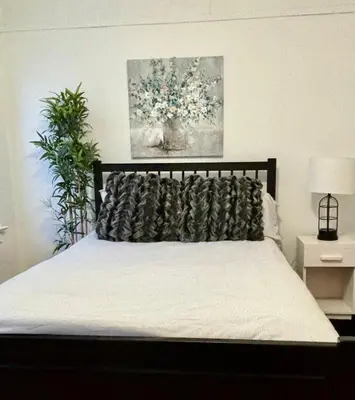 a bedroom with a bed with a pillow on it at The Mountain House in Lanesville