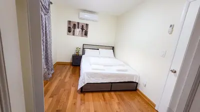 a bedroom with a bed and a wooden floor at Amazing private single family house in Glendale