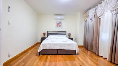 a bedroom with a bed and a wooden floor at Amazing private single family house in Glendale