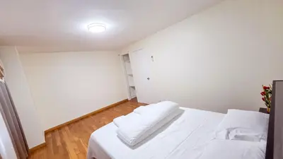 a bedroom with a white bed with two pillows at Amazing private single family house in Glendale