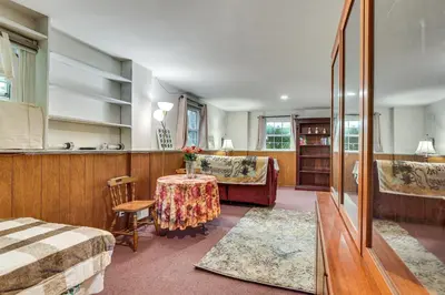 a room with a bed and a table with a couch at 2 Mi to NYC Train WFH-Friendly Greenwich Apt! in Greenwich