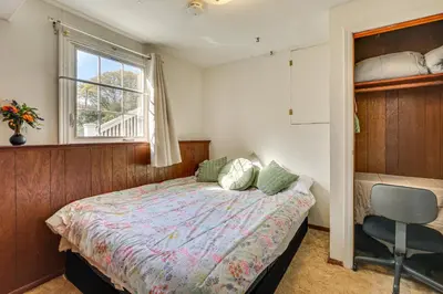 a bedroom with a bed and a window and a chair at 2 Mi to NYC Train WFH-Friendly Greenwich Apt! in Greenwich