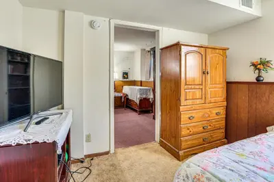 a room with a bedroom with a dresser and a bed at 2 Mi to NYC Train WFH-Friendly Greenwich Apt! in Greenwich