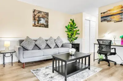 a living room with a couch and a table at TruStay in Central Connecticut in Manchester