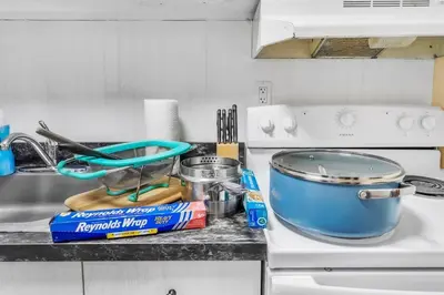 a kitchen counter with a pot on a stove at TruStay in Central Connecticut in Manchester
