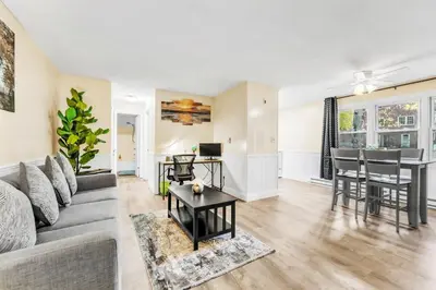 a living room with a couch and a table at TruStay in Central Connecticut in Manchester