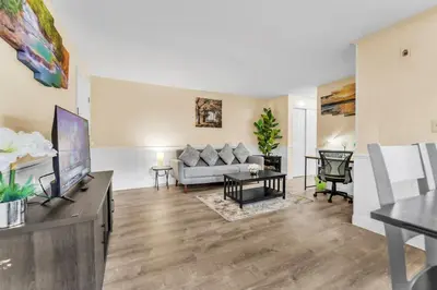 a living room with a couch and a tv at TruStay in Central Connecticut in Manchester
