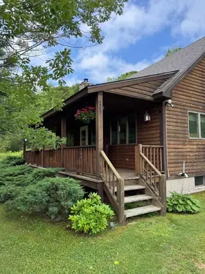 a wooden house with a porch and a deck at Mountain Retreat in the Catskills in Roxbury