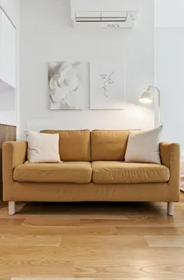 a brown couch in a living room at Elegant Studio Apartment in Steinway