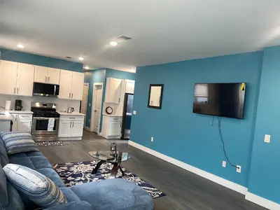 a living room with a couch and a blue wall at Peace Sterling Haven in Newark