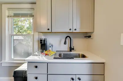 a white kitchen with a sink and a window at 2 Mi to Uptown Centrally Located Kingston Apt! in Kingston