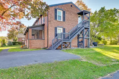 a brick house with a staircase on the side of it at 2 Mi to Uptown Centrally Located Kingston Apt! in Kingston