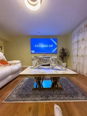 a living room with a coffee table in front of a tv at Sleeps 4 Guests Near Yale & Downtown - Free Parking in New Haven