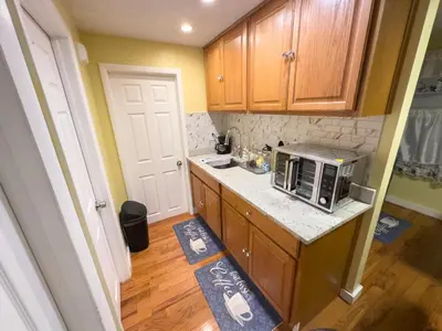 a small kitchen with a microwave on a counter at Sleeps 4 Guests Near Yale & Downtown - Free Parking in New Haven